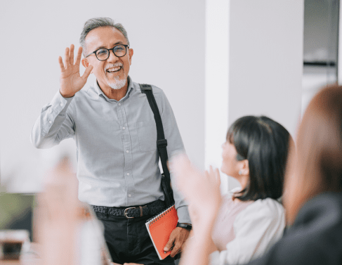 A friendly person waving at other people.